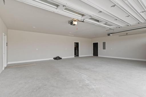 Fully finished oversized 3-car garage, offering plenty of room for your vehicles, storage, and more.