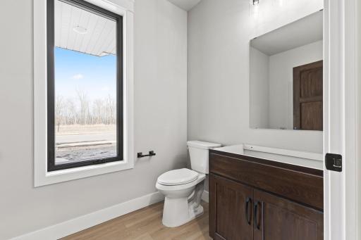 Off the mudroom, you'll find a half bath with washer and dryer hookups.