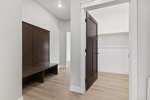 The mudroom off the garage features a built-in bench and a convenient coat/storage closet - perfect for keeping everything organized.