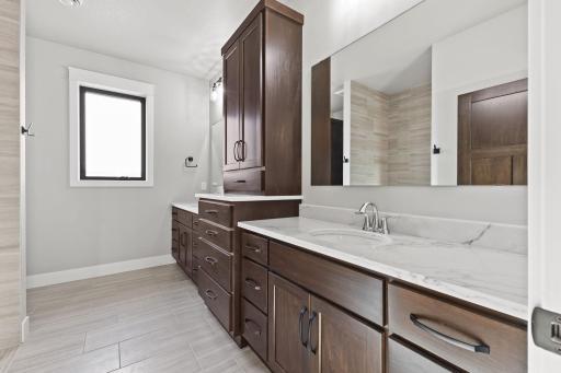 This 3/4 primary bathroom offer plenty of storage space and double sinks, combining style with practicality for your daily routines.