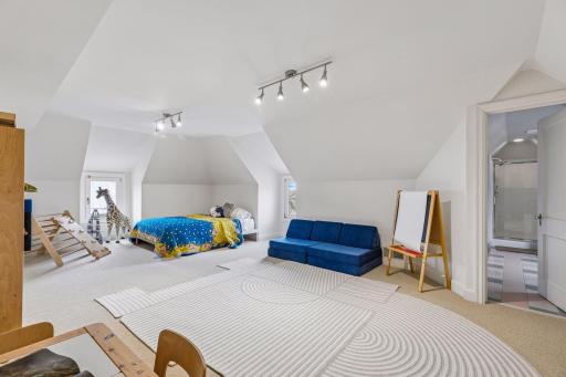 Fourth bedroom on the third level with a 3/4 en suite bathroom and walk-in shower.