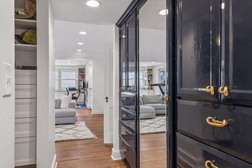 The primary suite includes a beautifully appointed walk-in closet with enameled cabinets.