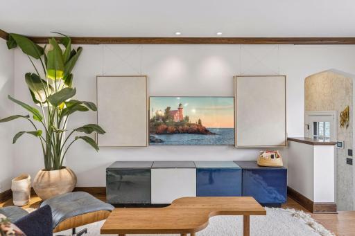 Custom art cleverly conceals the television.