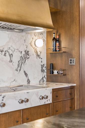 Gorgeous Oyster White Marble decorates the Gaggenau induction cooktop and teppanyaki grill.