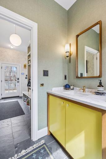 Main level powder room just off of the garage entrance and mudroom. The side door leads to the driveway.