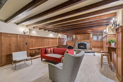 Finished lower level with a spacious recreation room, kitchenette with wet bar, and gas fireplace. Gorgeous wood paneled walls and wood beam ceilings.