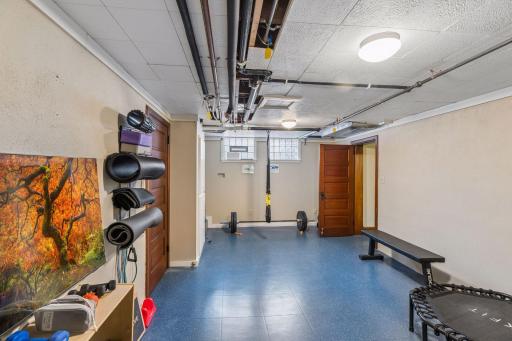 Lower level fitness room with tile floors.