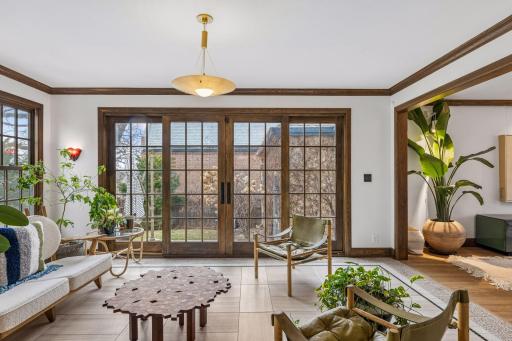 Main level sunroom with sliding French doors to the patio and private yard.