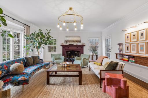 The spacious formal living room features a curved bay window, soaring ceilings, and a wood-burning fireplace. Direct access to the yard. Windows have been updated throughout the home.