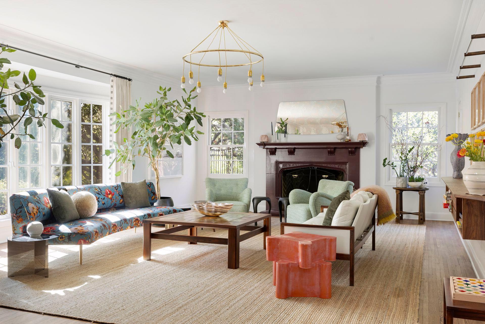 The spacious formal living room features a curved bay window, soaring ceilings, and a wood-burning fireplace. Direct access to the yard. Windows have been updated throughout the home.
