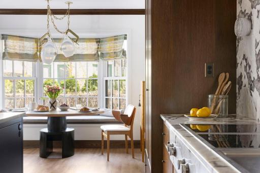 This kitchen not only exudes warmth and sophistication, but invites intimate gatherings around the breakfast table as well as entertaining around the 13' center island.