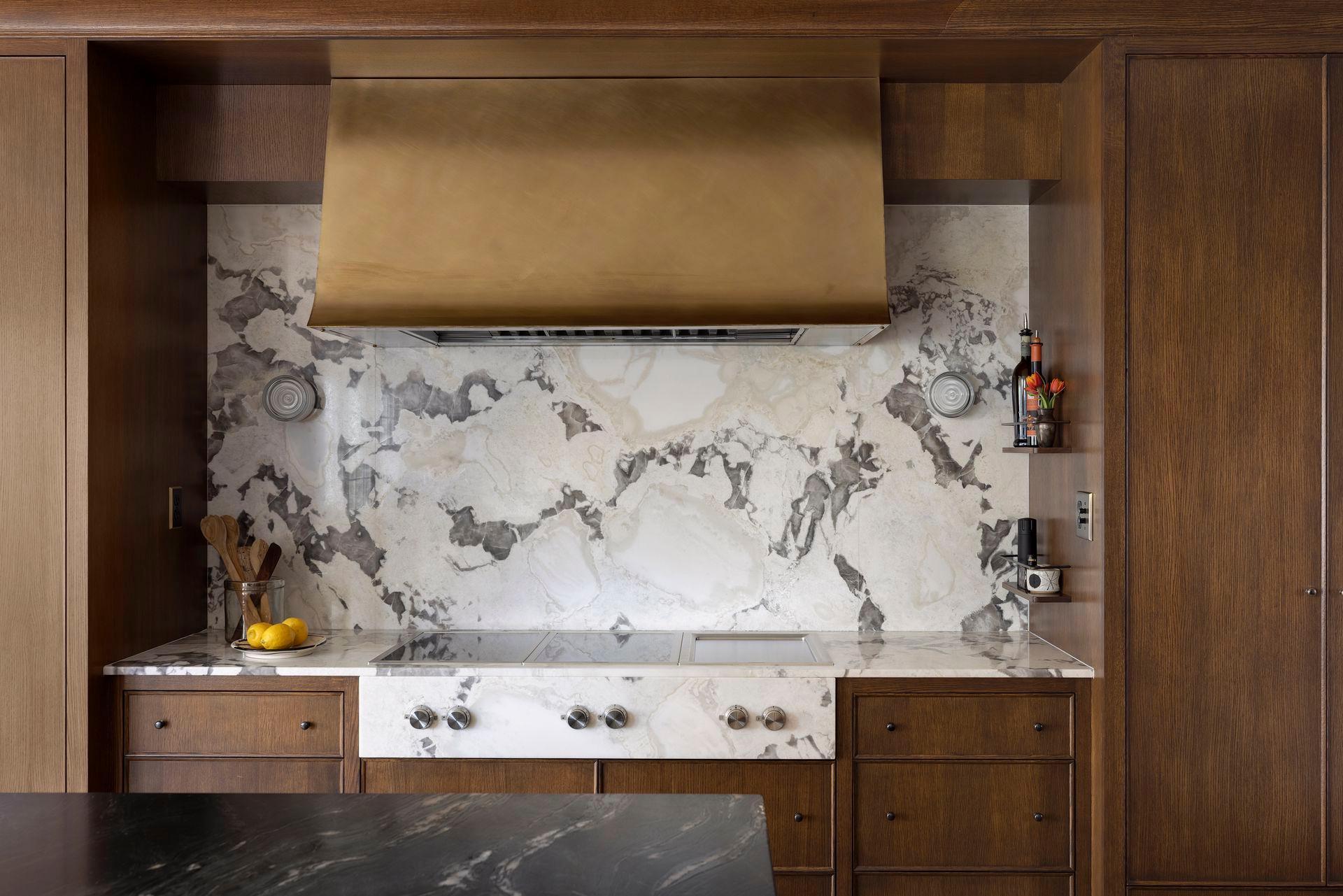 Stunning oyster marble counters and backsplash. Induction cooktop and teppanyaki grill. Designer exhaust hood. Integrated appliances.