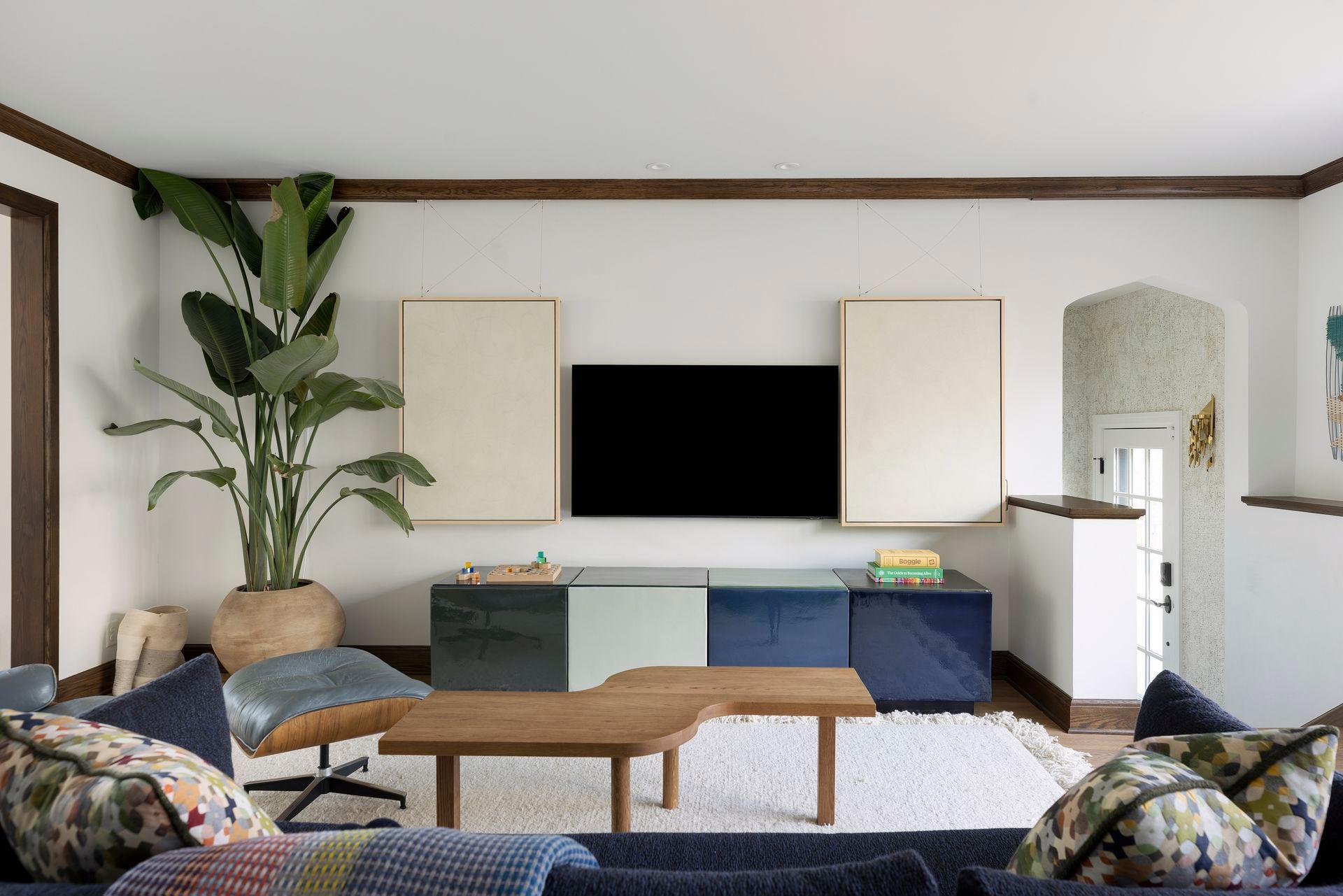 Custom art cleverly conceals the television.