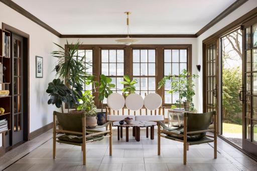 Inviting and light-filled four season sunroom with heated floors and double sliding doors with direct access to the patio and generous yard. French doors lead into the formal dining room.
