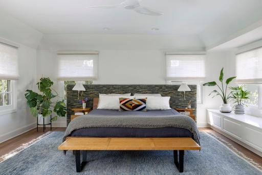 Generous primary suite with hardwood floors, automatic blinds, wonderful natural light and views.