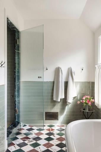 The east-facing primary bath enjoys beautiful morning light. Separate soaking tub and walk-in steam shower. Not pictured: private water closet.