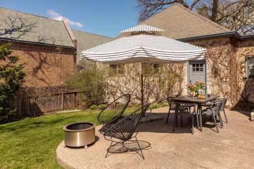 The front and back yards feature expansive lawns, a full irrigation system, a spacious patio, mature landscaping, and garden beds. Seasonal "peek a boo" views of Lake of the Isles.