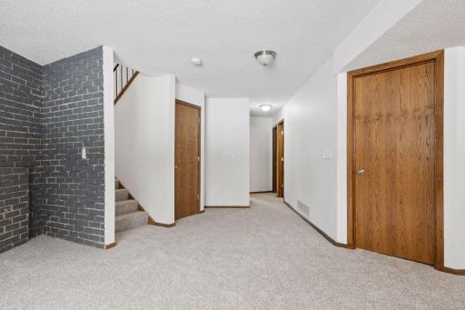 Family room opens to laundry, under stair storage, bathroom and two more bedrooms