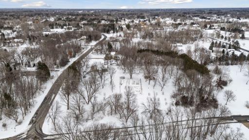 Mainly grass, level acreage with small fruit tree orchard, raised beds, storage buildings and more