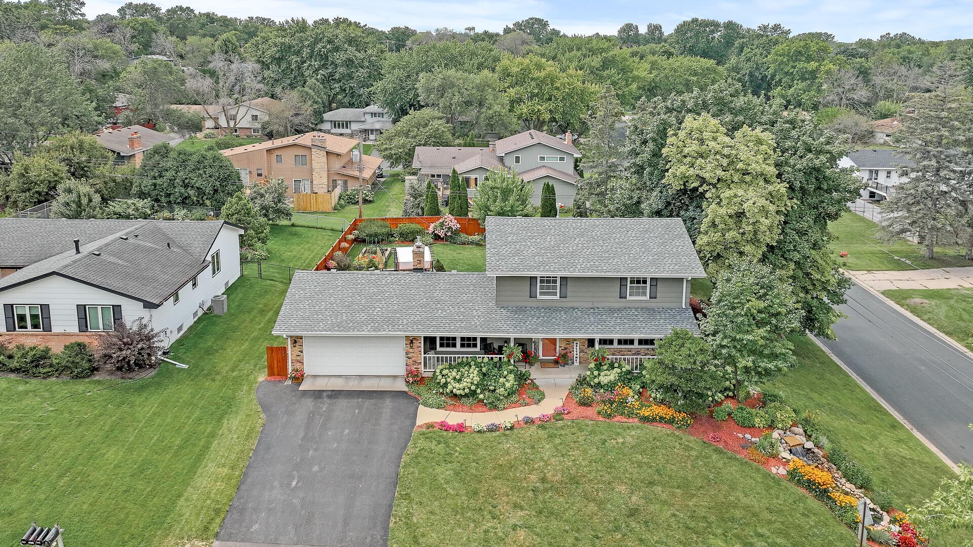 The neighborhood icon. Two-time RAVE Landscaping Award winner featuring professional masonry, cement board siding, and a brand-new roof (2025).