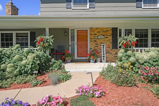 The ultimate greeting. An expansive, inviting front porch perfect for morning coffee while overlooking the award-winning gardens.