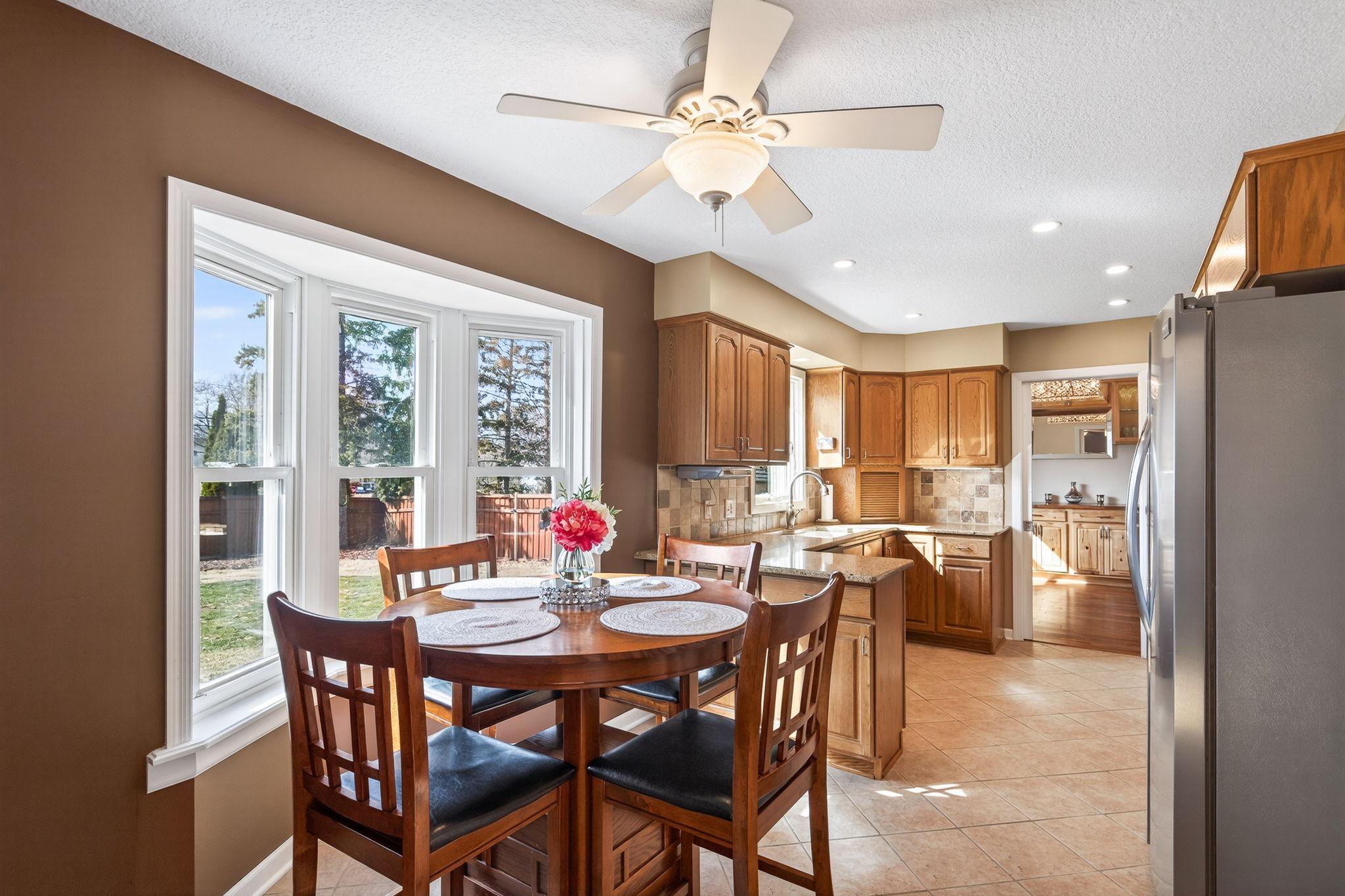 The heart of daily life. The informal dining area flows effortlessly from the kitchen, offering a sun-filled spot to gather.