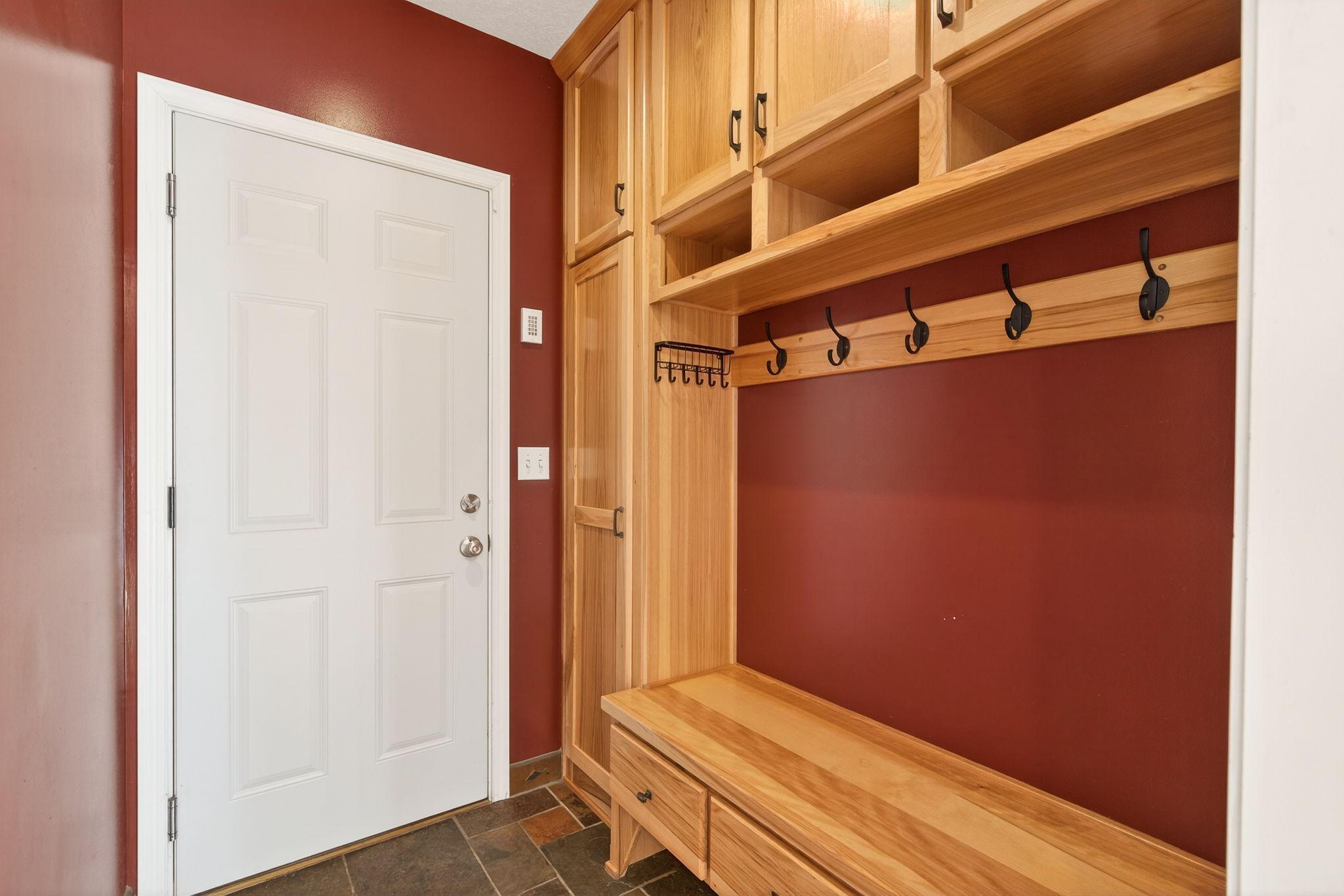 The ultimate drop zone. Conveniently located between the garage and family room, this transition space features custom built-in cubbies for bags and keys, plus a generous coat closet.