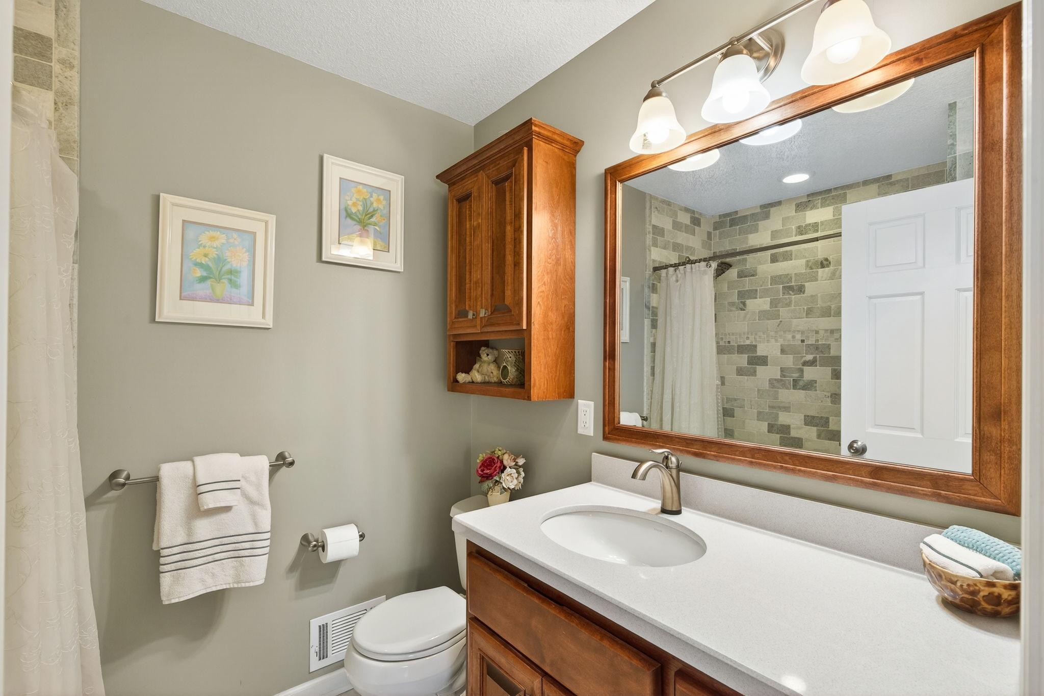 The upper level is completed by a spacious full bathroom serving the three guest bedrooms.
