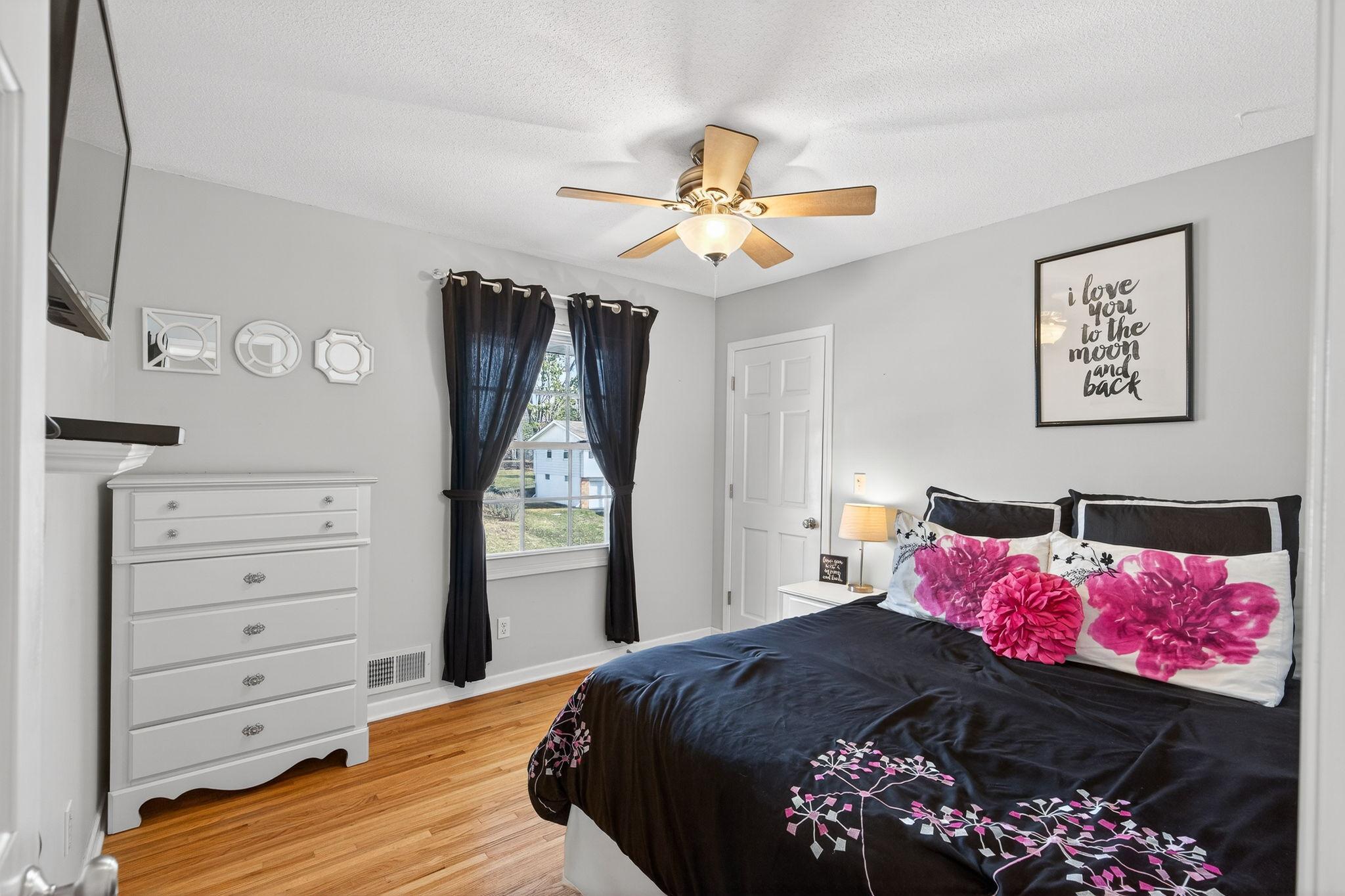 Consistency in quality. The second guest bedroom boasts beautiful hardwood floors and a surprisingly deep closet, offering plenty of room for a growing family or guests.