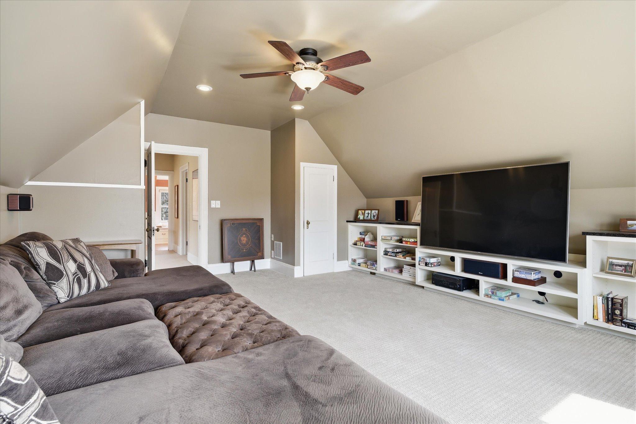 Large family room on 3rd floor with built in shelves