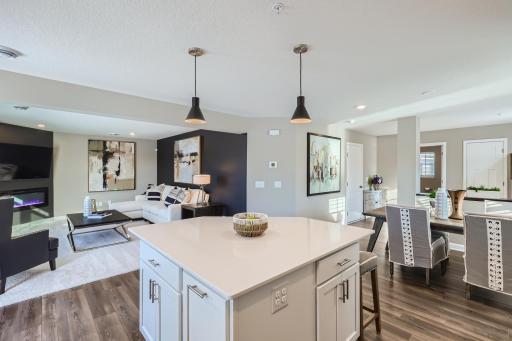 (Photo of a decorated model, actual homes finishes will vary) The open layout allows for an easy flow between each of the living areas.