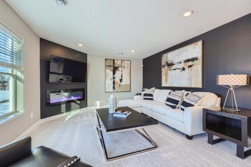 (Photo of a decorated model, actual homes finishes will vary) Cozy up next to the fireplace.