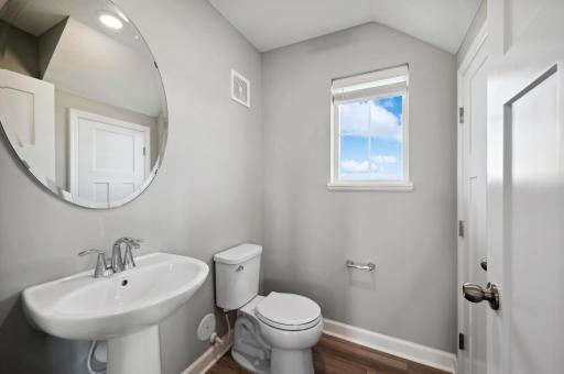 (Photo of a decorated model, actual homes finishes will vary) Main level powder bath.