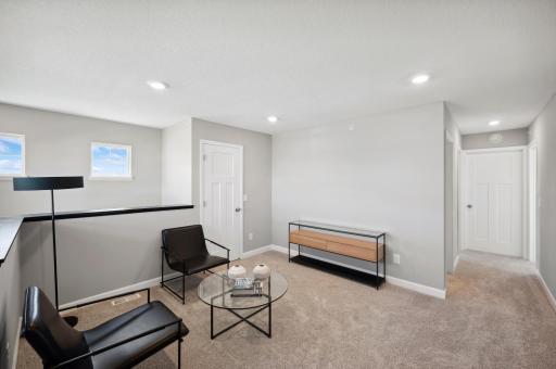 (Photo of a decorated model, actual homes finishes will vary) The upstairs loft can be used in versatile ways such as a comfortable sitting room for watching TV together.