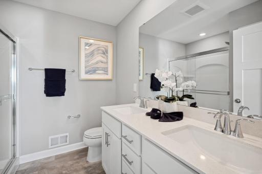 (Photo of a decorated model, actual homes finishes will vary) Dual sinks in the owner's bathroom provide plenty of room for each of the homeowners.