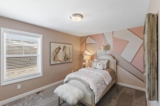(Photo of a decorated model, actual homes finishes will vary) This home's two secondary bedrooms provide personal space for younger family members or overnight guests.