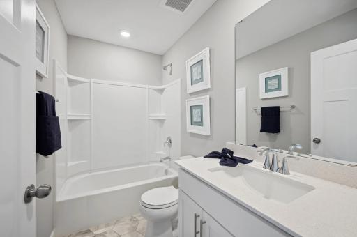 (Photo of a decorated model, actual homes finishes will vary) The spacious secondary bath.