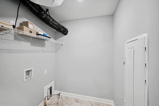 (Photo of a decorated model, actual homes finishes will vary) Upper level laundry!
