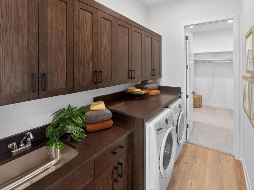 Laundry Room- built-in laundry sink, base and upper cabinets, and quartz countertop above appliances