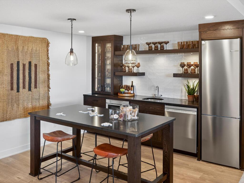 Lower Level Bar, complete with appliances, custom cabinets & floating shelve, build in bar table, and LVP flooring