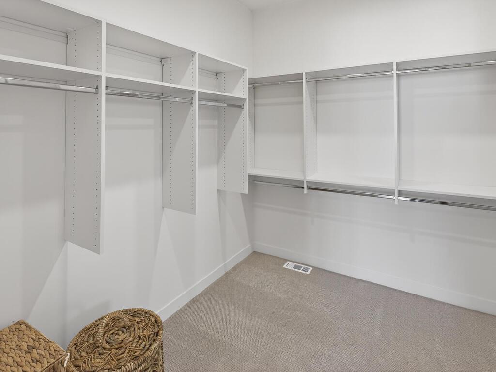 Primary Bedroom WIC with custom shelving system