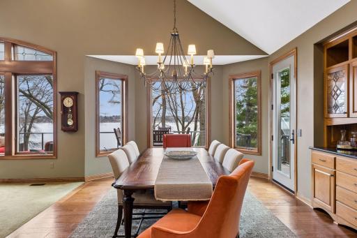The dining area flows seamlessly to the living space, with lake views and direct access to the deck for easy indoor-outdoor living.