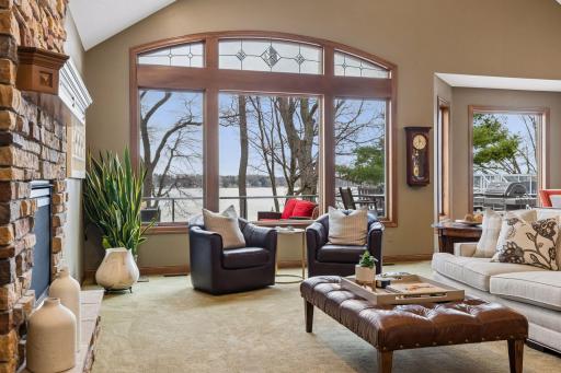 Large windows frame serene lake views, bringing natural light and the outdoors into the main living space.