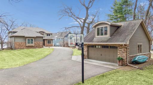 The driveway and detached garage provide additional space for vehicles, storage, or hobby use.