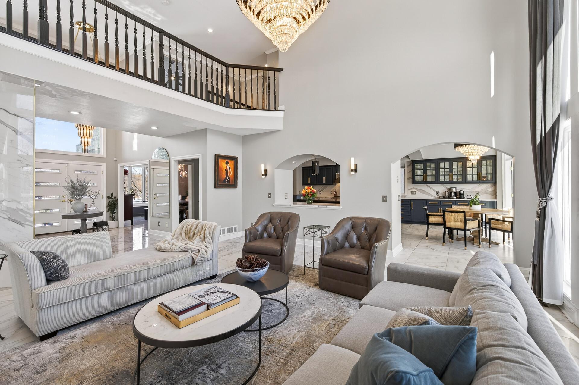 A different perspective from the main-level family room, featuring views of the foyer and nearby kitchen and dining room.