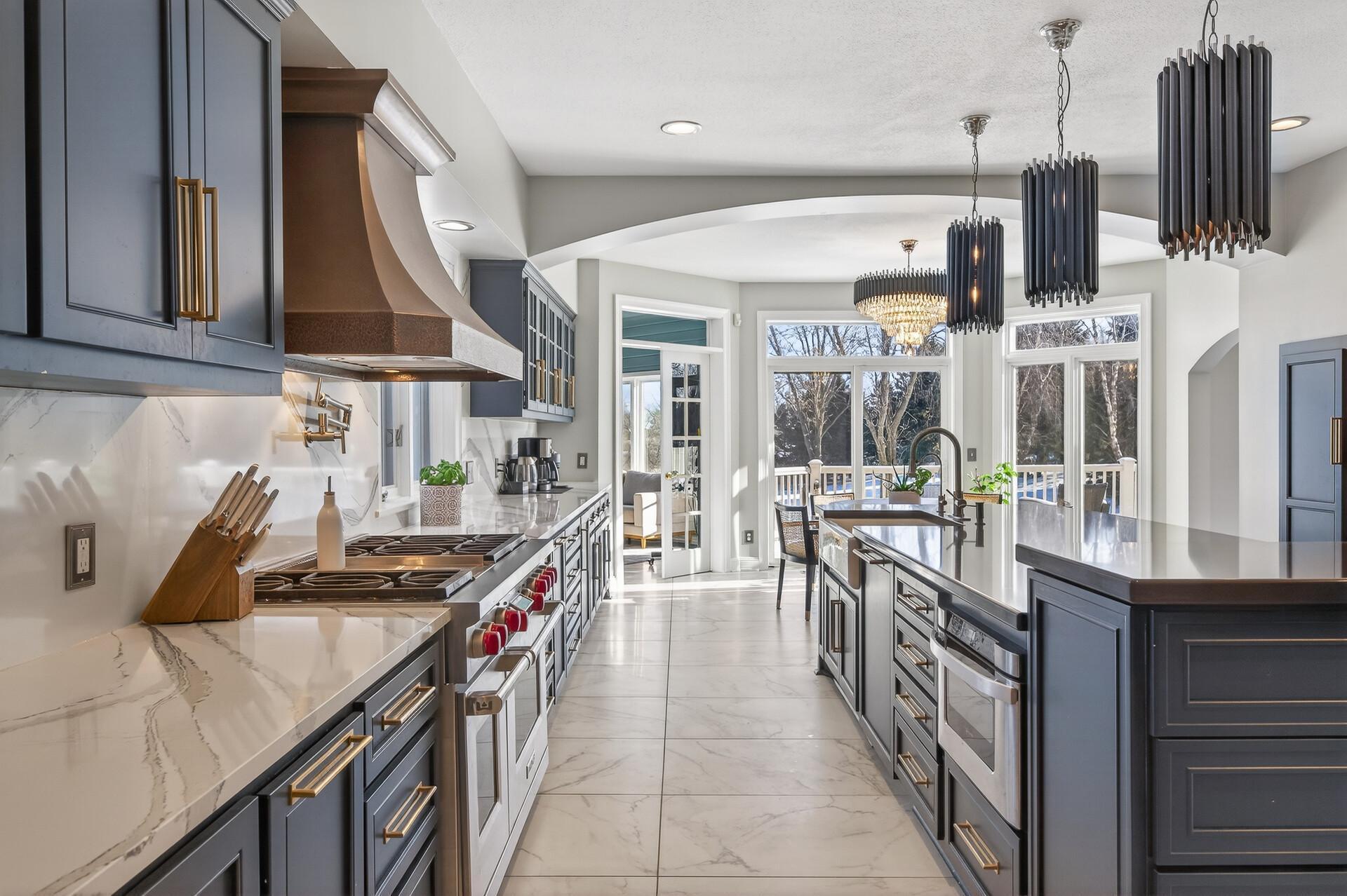 Stylish soft-close cabinetry and stainless steel appliances complete the space, highlighted by a high-end Wolf range and oven.