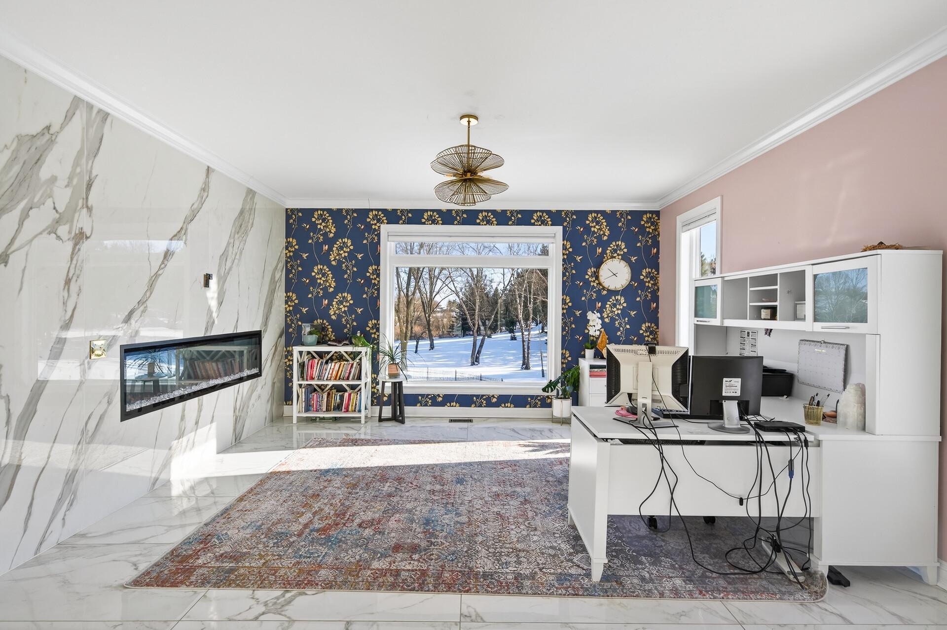 Marble flooring continues throughout the space, while a large window provides abundant natural light and serene backyard views.