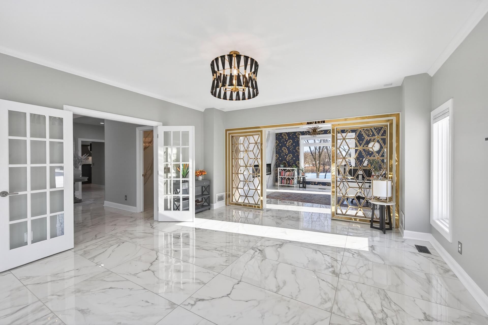 The office also offers direct access to the main-level living room through a striking gold-accented arched entryway.