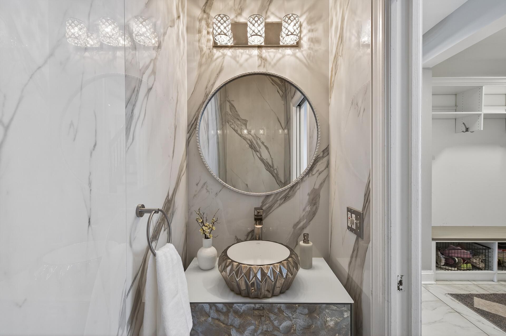 Nearby, a convenient half bathroom serves the laundry and mudroom areas.