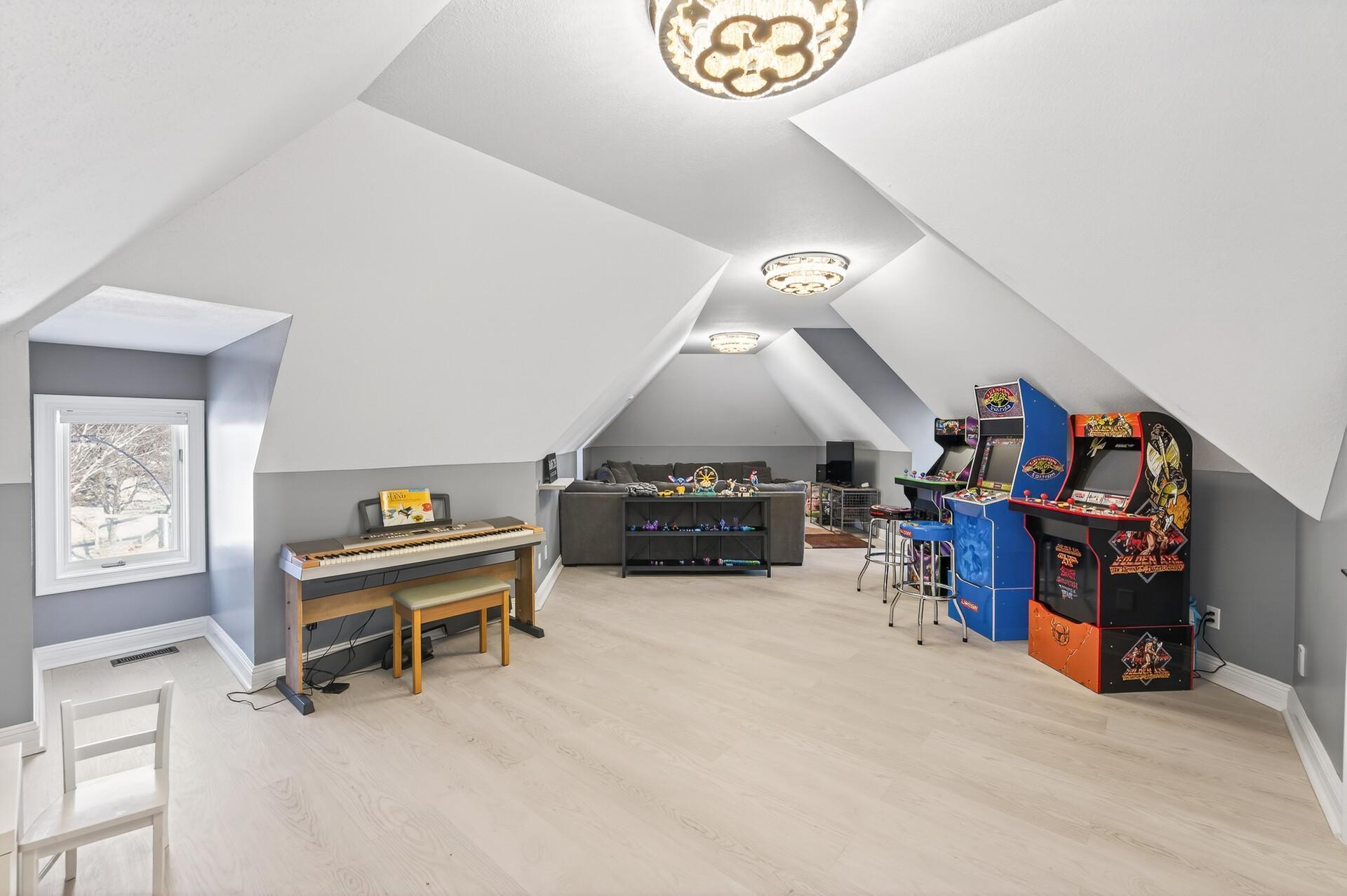 The expansive bonus room located above the garage—an ideal space for a game room, playroom, or additional living area.